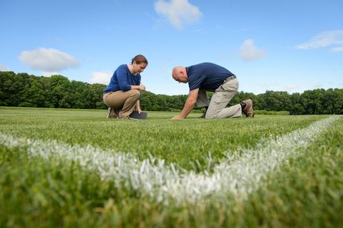 researchers analyzing soil